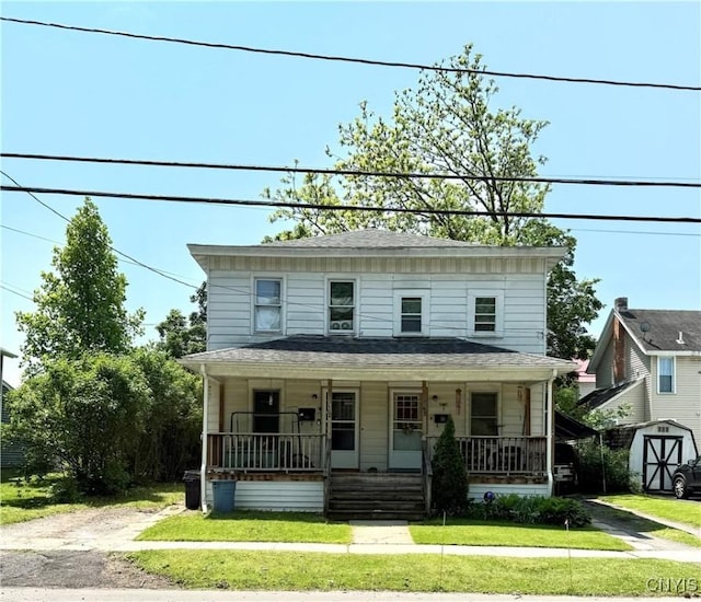 58-60 Lansing St, Auburn, NY 13021 - traditional style home featuring a porch and a front yard