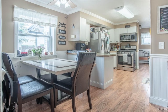 18916 State Route 3, Hounsfield, NY 13601 - dining area featuring ornamental molding, a ceiling fan, light wood-style floors, and wainscoting