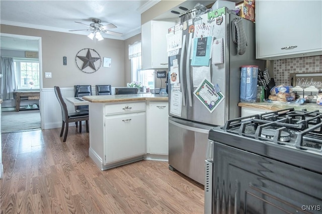 18916 State Route 3, Hounsfield, NY 13601 - kitchen with crown molding, white cabinets, a peninsula, light countertops, and black range with gas cooktop