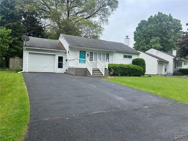 719 Dawes Ave, Utica, NY 13502 - ranch-style house featuring an attached garage, a chimney, asphalt driveway, a front lawn, and covered porch