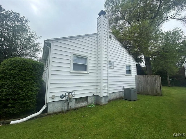 719 Dawes Ave, Utica, NY 13502 - view of home's exterior with central AC unit and a chimney