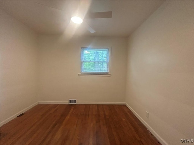 719 Dawes Ave, Utica, NY 13502 - spare room with dark wood finished floors, baseboards, and a ceiling fan