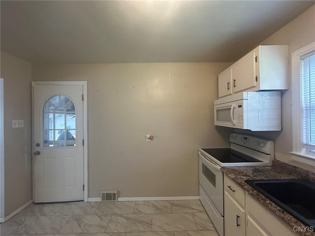 719 Dawes Ave, Utica, NY 13502 - kitchen with white appliances, plenty of natural light, light marble finish floors, and white cabinetry