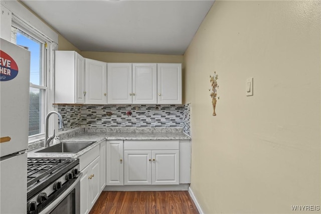 159 Kilhoffer St, Buffalo, NY 14211 - kitchen featuring stainless steel range with gas cooktop, a sink, tasteful backsplash, freestanding refrigerator, and white cabinets