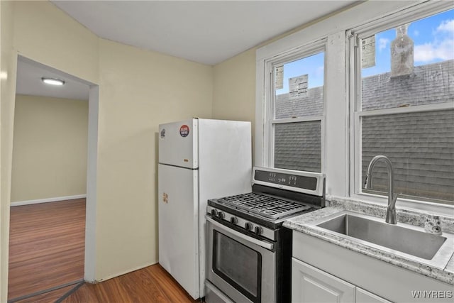 159 Kilhoffer St, Buffalo, NY 14211 - kitchen with stainless steel gas stove, a sink, wood finished floors, and light countertops