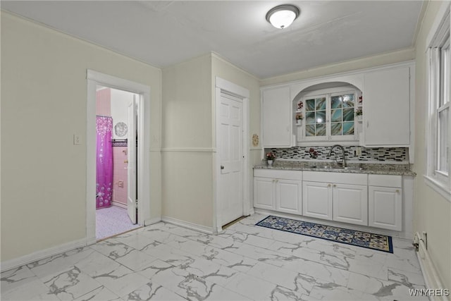 159 Kilhoffer St, Buffalo, NY 14211 - bathroom featuring marble look tile flooring, vanity, backsplash, and baseboards