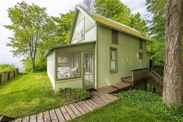7732 Lake Blf, Huron, NY 14590 - back of house featuring a wooden deck, a sunroom, a lawn, and a shingled roof