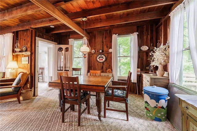 7732 Lake Blf, Huron, NY 14590 - dining space with wood walls, wooden ceiling with exposed beams, and light carpet