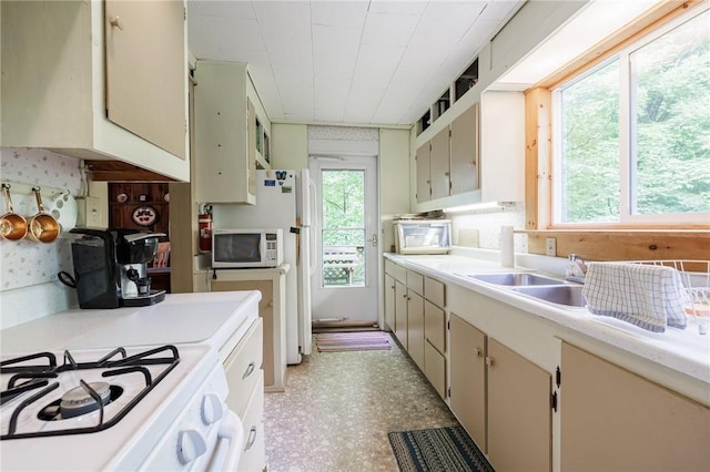 7732 Lake Blf, Huron, NY 14590 - kitchen with white appliances, light countertops, a sink, light floors, and cream cabinetry