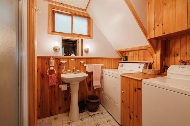 7732 Lake Blf, Huron, NY 14590 - laundry area with washing machine and dryer, a wainscoted wall, wooden walls, and light floors