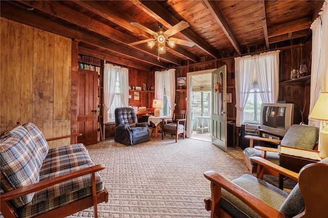 7732 Lake Blf, Huron, NY 14590 - living area featuring wood walls, wooden ceiling with exposed beams, carpet, and ceiling fan