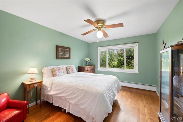 139 Capitol Street Ext, Sennett, NY 13021 - bedroom featuring a baseboard radiator, wood finished floors, baseboards, and ceiling fan
