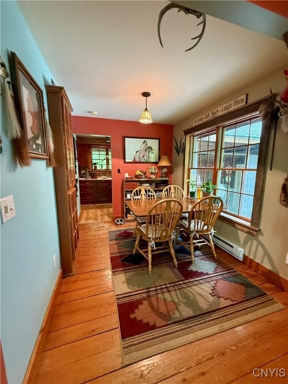 3805 State Highway 80, Columbus, NY 13460 - dining room with light wood-type flooring, baseboards, and a baseboard heating unit