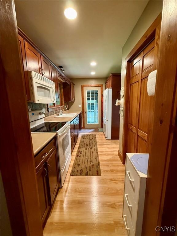 3805 State Highway 80, Columbus, NY 13460 - kitchen featuring white appliances, light wood finished floors, light countertops, a sink, and recessed lighting