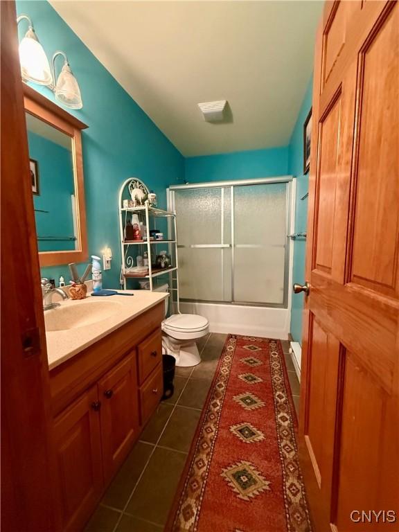 3805 State Highway 80, Columbus, NY 13460 - full bath with vanity, toilet, bath / shower combo with glass door, tile patterned flooring, and lofted ceiling