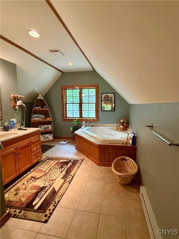 3805 State Highway 80, Columbus, NY 13460 - bathroom featuring vanity, a jetted tub, vaulted ceiling, tile patterned flooring, and a baseboard radiator