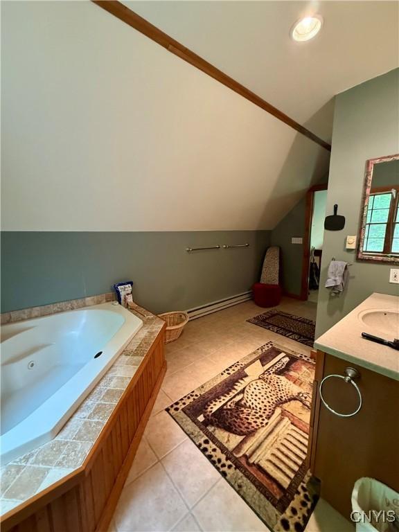 3805 State Highway 80, Columbus, NY 13460 - bathroom with a baseboard heating unit, vanity, a jetted tub, vaulted ceiling, and tile patterned floors