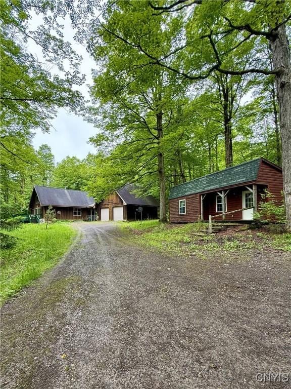 3805 State Highway 80, Columbus, NY 13460 - single story home featuring driveway, a garage, an outdoor structure, and covered porch
