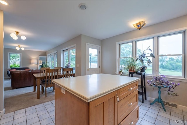 3871 Skyline Dr, Kirkland, NY 13323 - kitchen with light tile patterned floors, light countertops, a center island, and open floor plan