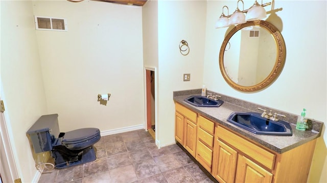 1547 Great Gully Rd, Springport, NY 13160 - bathroom with double vanity, toilet, and baseboards