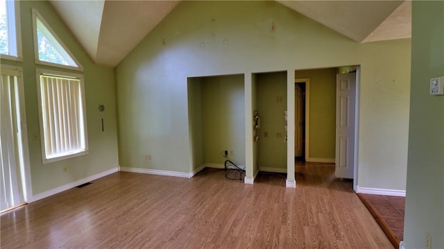 1547 Great Gully Rd, Springport, NY 13160 - unfurnished living room with lofted ceiling, wood finished floors, and baseboards