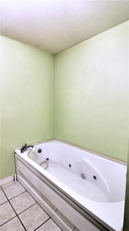 1547 Great Gully Rd, Springport, NY 13160 - full bathroom with a jetted tub, tile patterned flooring, and baseboards