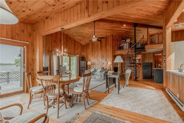 48785 Bamerick Rd, Alexandria, NY 13679 - dining area featuring wooden walls, light wood finished floors, wooden ceiling, stairs, and a baseboard radiator