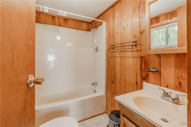 48785 Bamerick Rd, Alexandria, NY 13679 - bathroom with wooden walls, toilet, vanity, and shower / bath combination