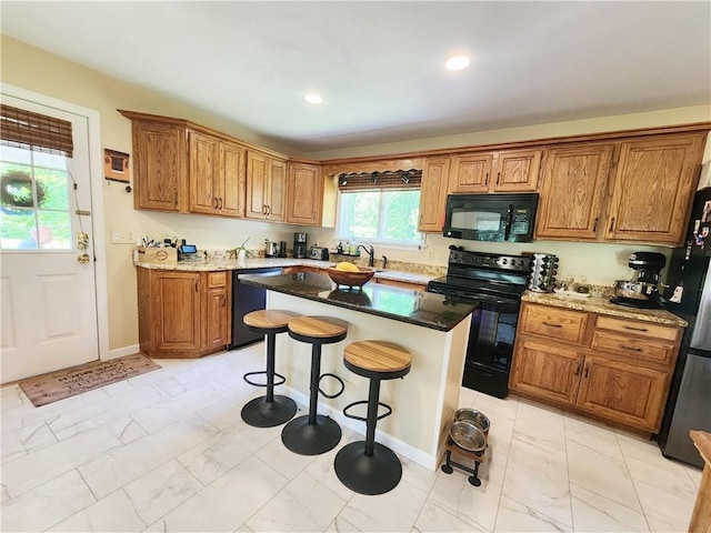 1305 Wyncoop Creek Rd, Chemung, NY 14825 - kitchen with black appliances, light marble finish floors, brown cabinets, a breakfast bar, and stone counters