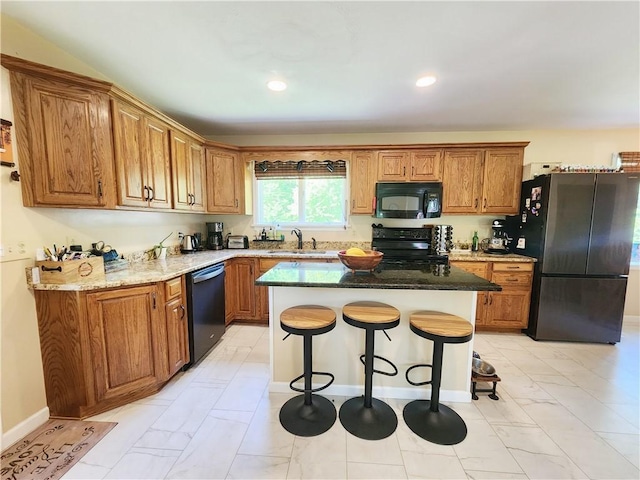 1305 Wyncoop Creek Rd, Chemung, NY 14825 - kitchen with black appliances, light marble finish floors, a breakfast bar, brown cabinetry, and a kitchen island