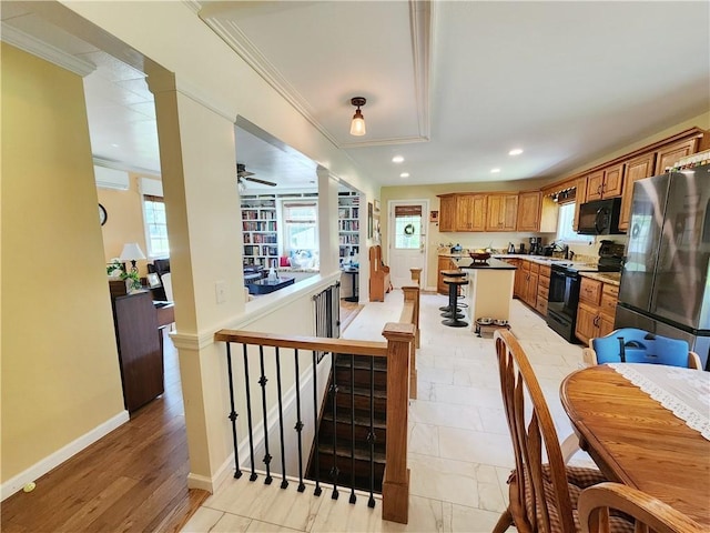 1305 Wyncoop Creek Rd, Chemung, NY 14825 - kitchen with black appliances, brown cabinetry, recessed lighting, healthy amount of natural light, and ornamental molding
