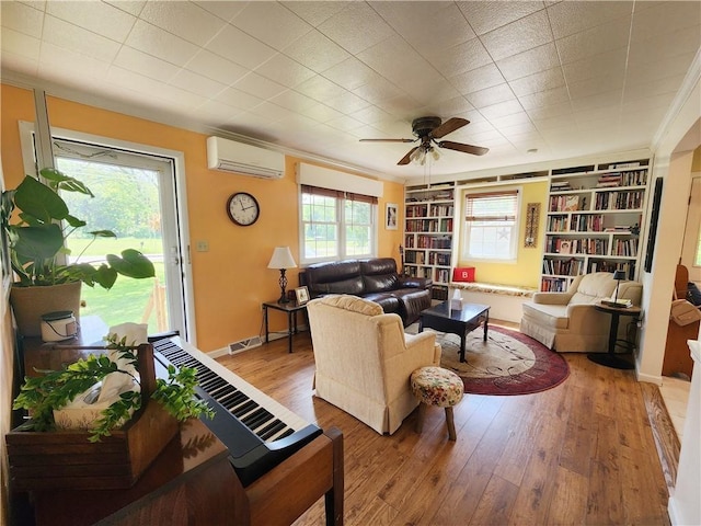 1305 Wyncoop Creek Rd, Chemung, NY 14825 - living room with a wall unit AC, ceiling fan, hardwood / wood-style floors, ornamental molding, and built in shelves