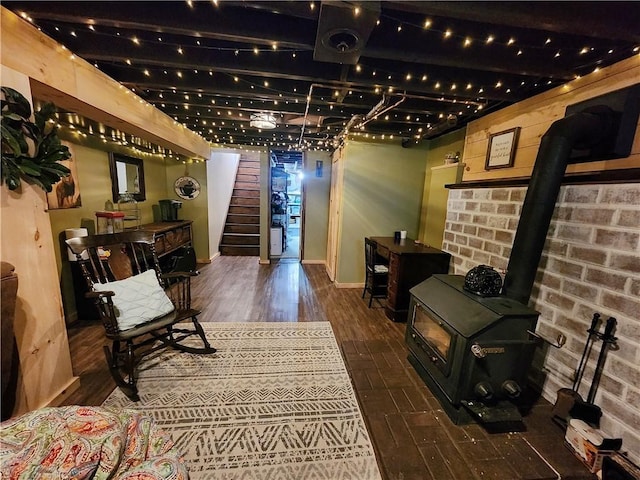 1305 Wyncoop Creek Rd, Chemung, NY 14825 - sitting room featuring a wood stove, stairs, wood finished floors, and baseboards