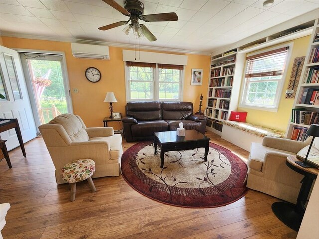 1305 Wyncoop Creek Rd, Chemung, NY 14825 - living area featuring a wall unit AC, ornamental molding, wood-type flooring, built in features, and ceiling fan