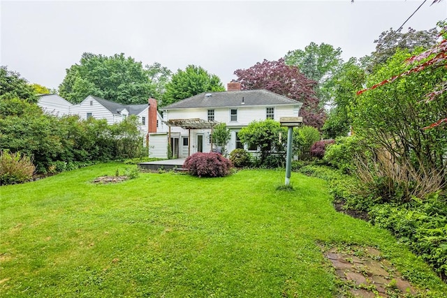 68 Colonial Village Rd, Brighton, NY 14625 - rear view of house featuring a pergola, a yard, and a chimney