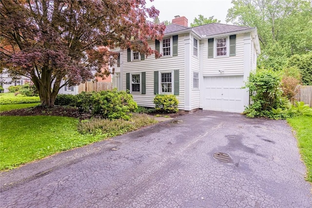 68 Colonial Village Rd, Brighton, NY 14625 - colonial home featuring a chimney, a garage, and asphalt driveway