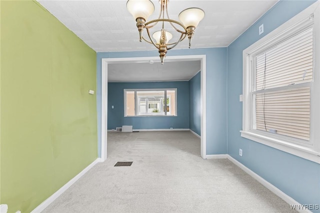 103 Ledger St, Buffalo, NY 14216 - empty room with a chandelier, carpet flooring, and baseboards