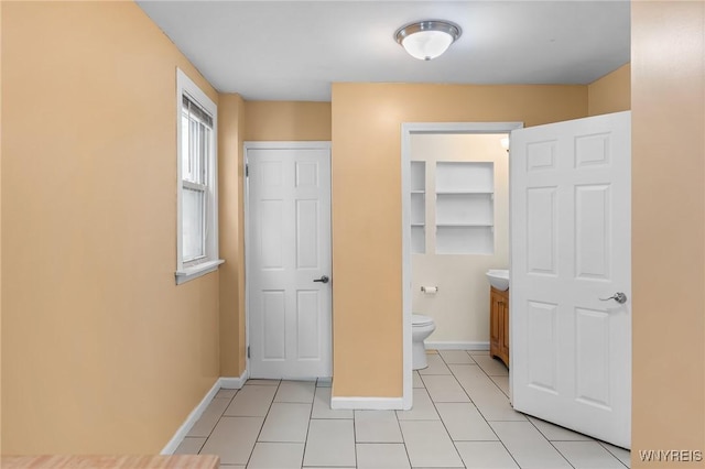 103 Ledger St, Buffalo, NY 14216 - unfurnished bedroom featuring light tile patterned floors, baseboards, and connected bathroom