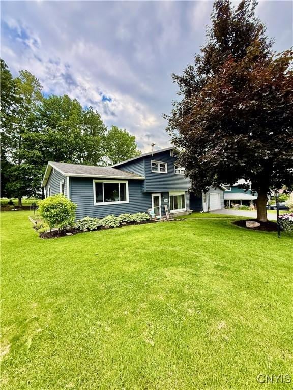 2718 Forest Hill Dr, Fleming, NY 13021 - tri-level home featuring a front lawn and an attached garage