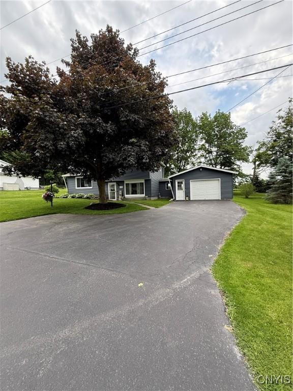 2718 Forest Hill Dr, Fleming, NY 13021 - view of front facade featuring a garage, a front yard, and driveway