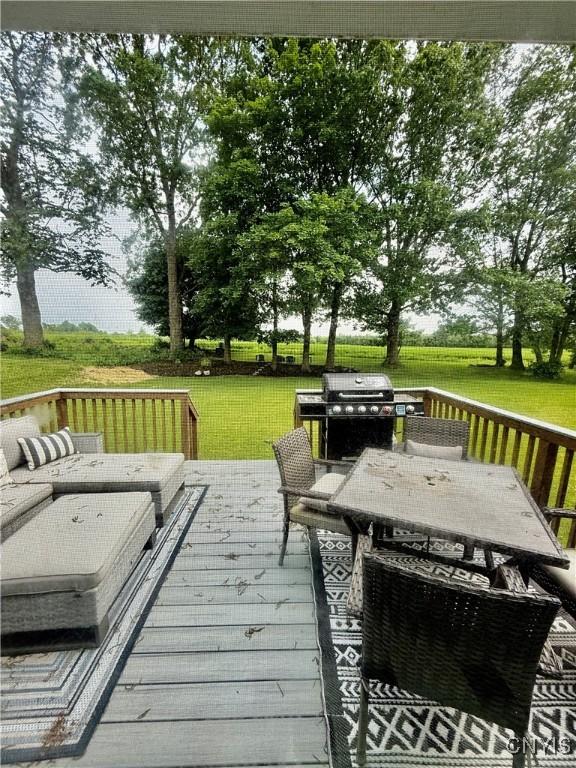 2718 Forest Hill Dr, Fleming, NY 13021 - wooden terrace featuring outdoor dining area, a lawn, and grilling area