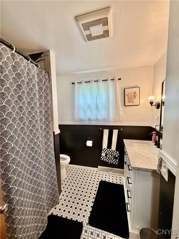 2718 Forest Hill Dr, Fleming, NY 13021 - full bathroom with toilet, vanity, tile patterned floors, and a shower with shower curtain