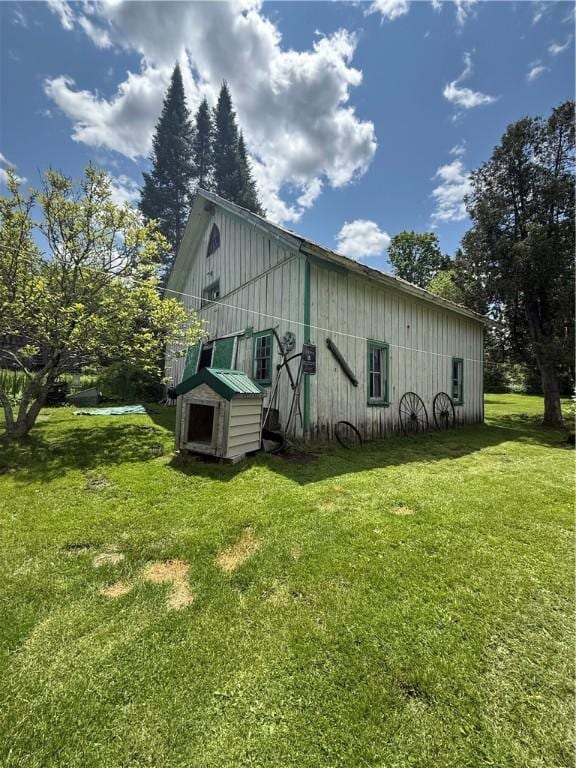3679 County Highway 35, Middlefield, NY 13450 - view of side of property featuring a yard, an outdoor structure, and board and batten siding