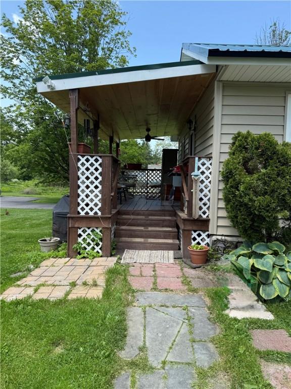 3679 County Highway 35, Middlefield, NY 13450 - porch with ceiling fan and a lawn