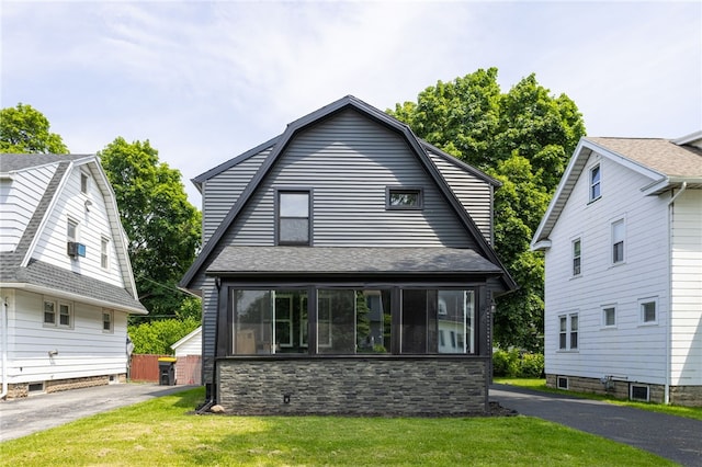74 Everett St, Greece, NY 14615 - colonial inspired home featuring a front lawn, a shingled roof, and stone siding