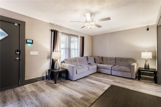 74 Everett St, Greece, NY 14615 - living area with ceiling fan, wood finished floors, baseboards, and a textured ceiling