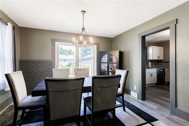 74 Everett St, Greece, NY 14615 - dining area featuring a chandelier and wood finished floors