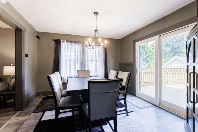 74 Everett St, Greece, NY 14615 - dining room with wood finished floors, a chandelier, and baseboards