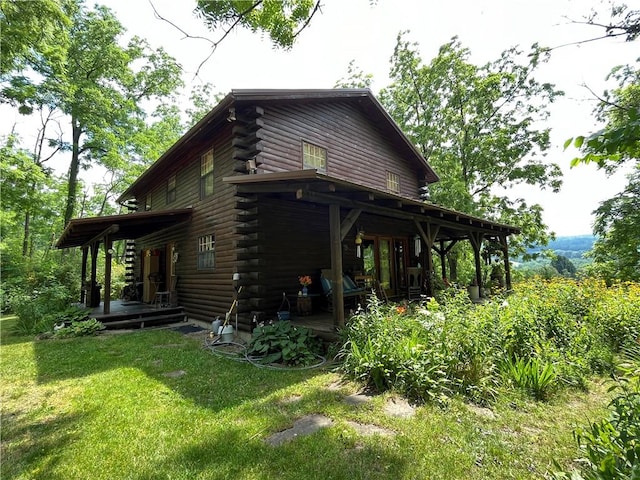 3921 State Route 226, Tyrone, NY 14837 - view of side of home featuring log exterior, a yard, and covered porch