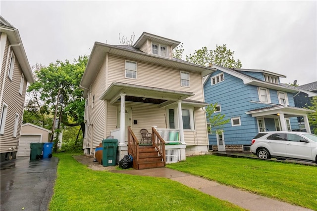 127 Devonshire Ct, Rochester, NY 14619 - american foursquare style home featuring a porch, an outbuilding, a garage, and a front yard